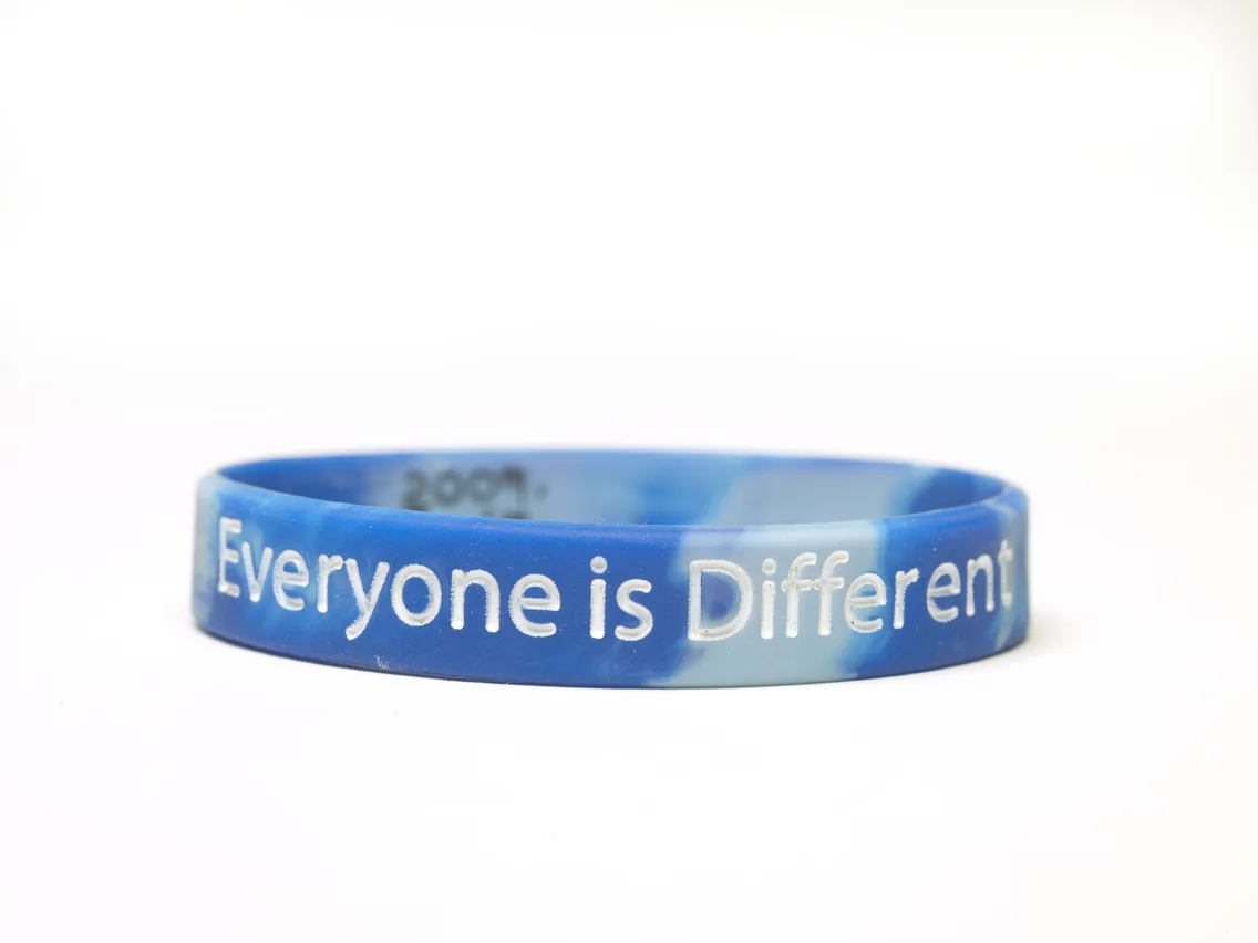 Blue silicone wristband with the inscription "everyone is different" highlighted in white, set against a white background.