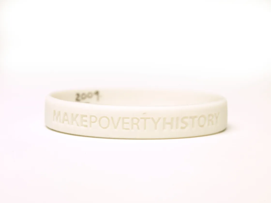 White silicone wristband with the words "makepovertyhistory" and "2005" embossed on it, set against a plain white background.