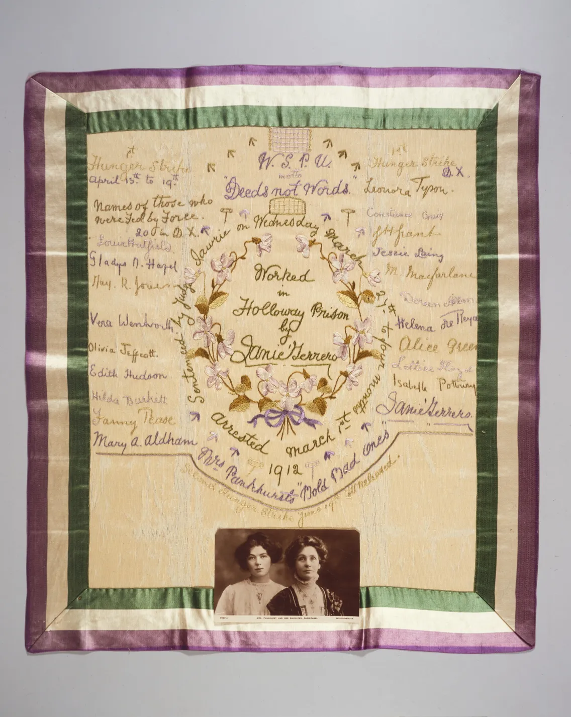 Vintage commemorative silk handkerchief featuring embroidered text and images of two women, framed by a decorative border.
