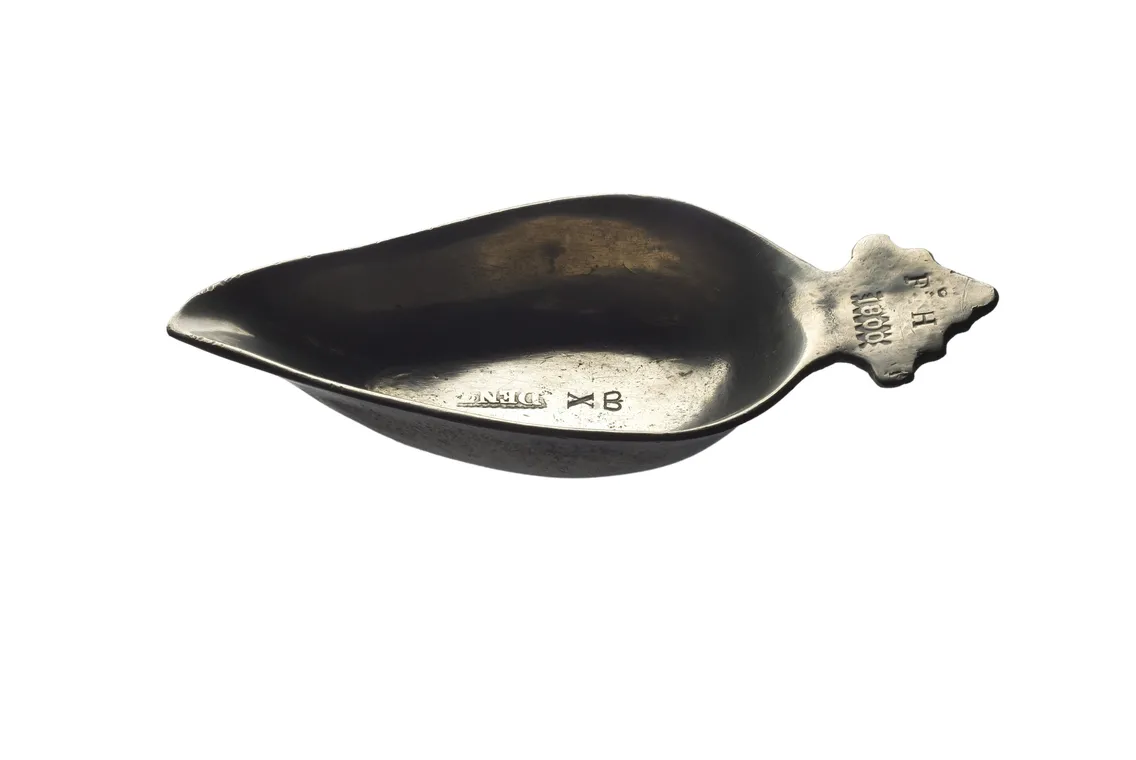 Antique silver spoon with engraved details and the year 1891, isolated on a white background.