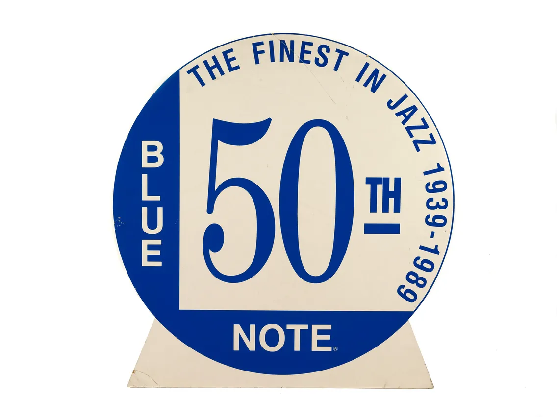 Blue and white circular sign celebrating the 50th anniversary of blue note, labeled "the finest in jazz", with years 1939-1989.