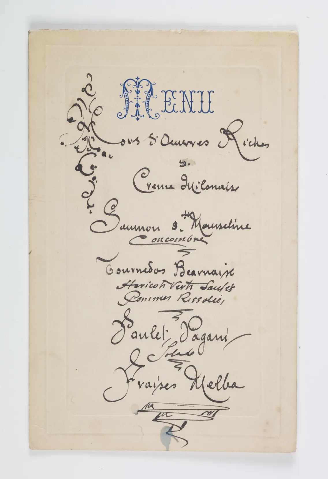Vintage menu with decorative script and ornamental designs, featuring a variety of dishes, on an aged background.