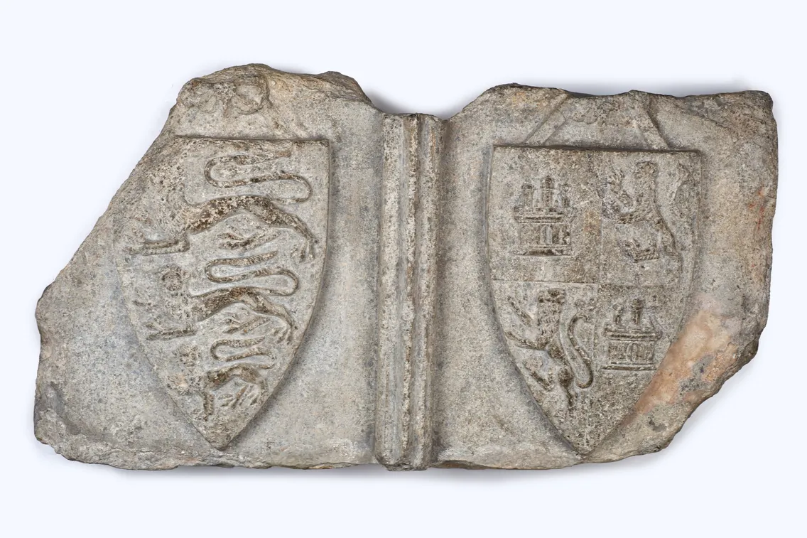 A stone relief depicting two shields: the left with three lions passant, the right quartered with castles and lions rampant, once graced Cheapside near the Eleanor Cross of Purbeck stone.