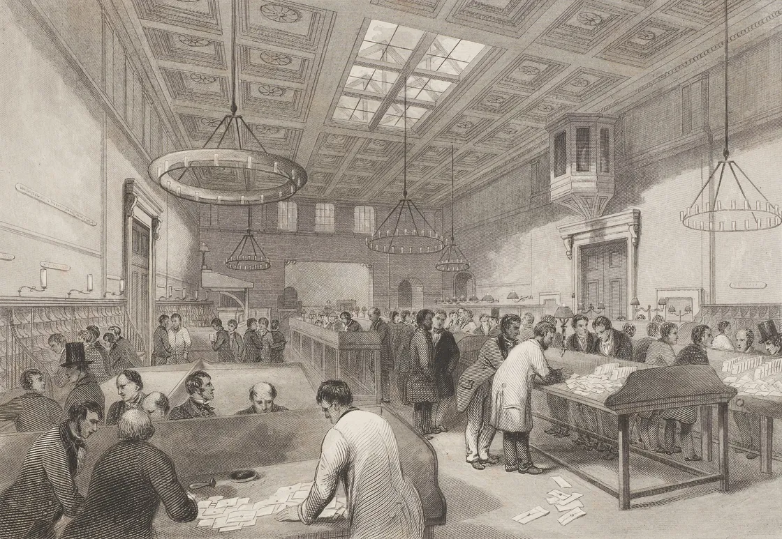 A busy, high-ceilenged room with lots of men stood working at desks with letters on
