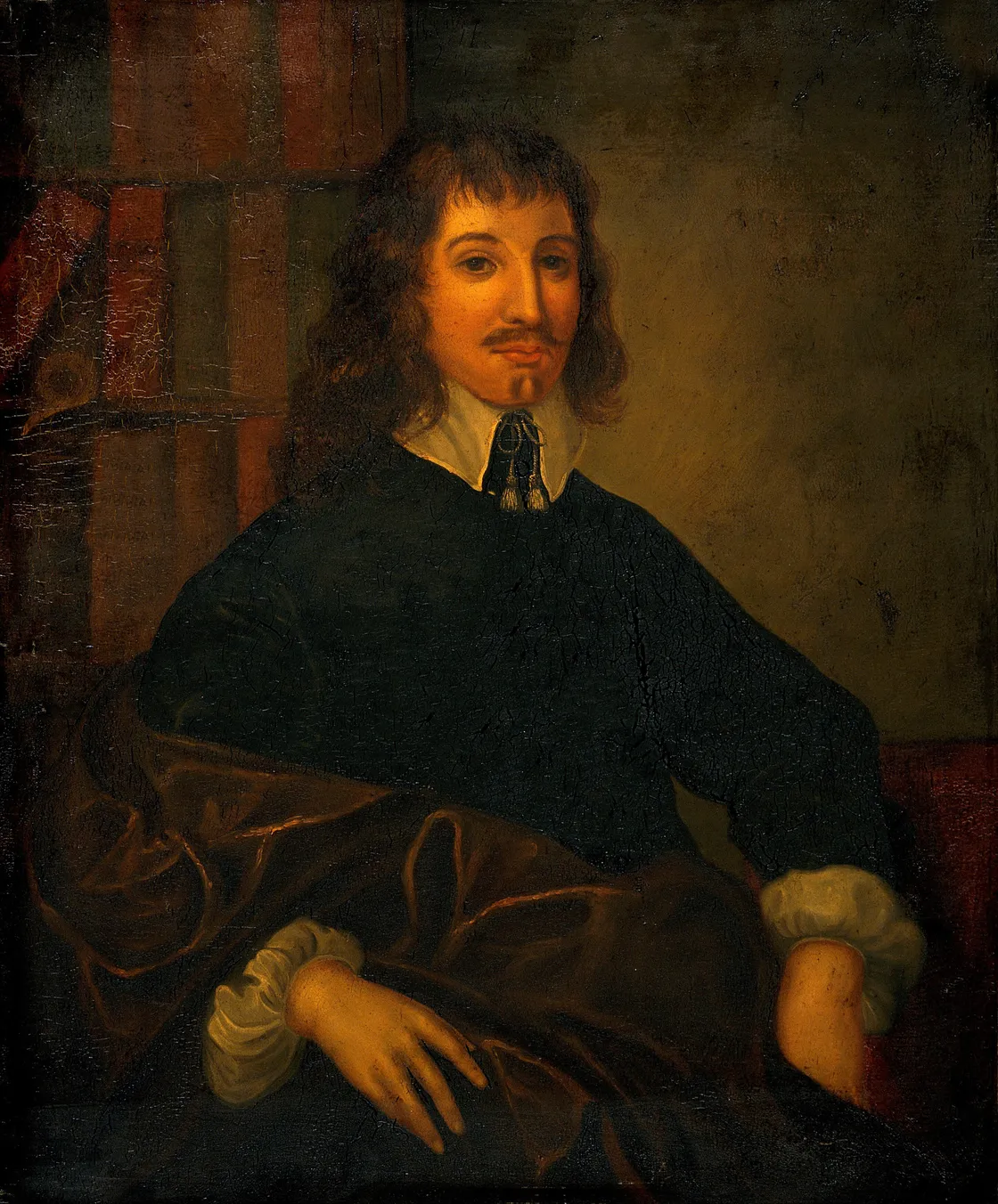 A man with long hair, a mustache, and a goatee, wearing period clothing with a white collar—reminiscent of portraits from the time of Culpeper—sits with one arm resting on a draped surface.