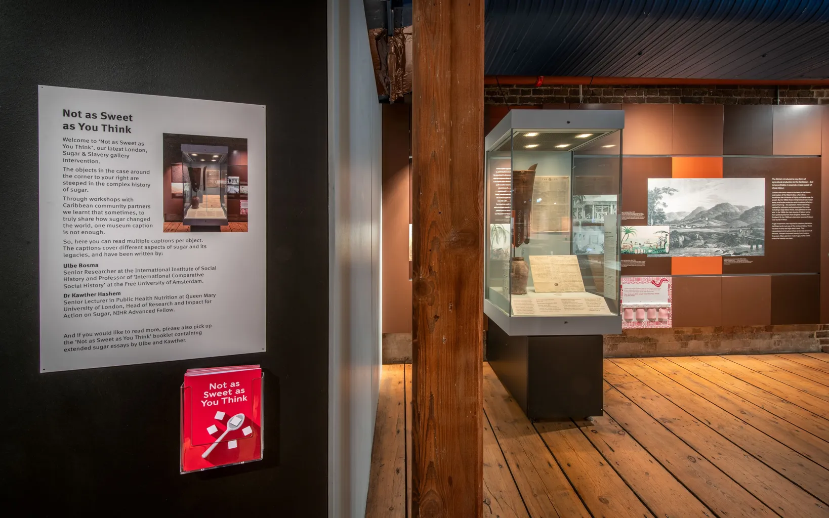 Interior of a gallery space with a mounted text panel on the left headed with 'Not as Sweet as You Think'