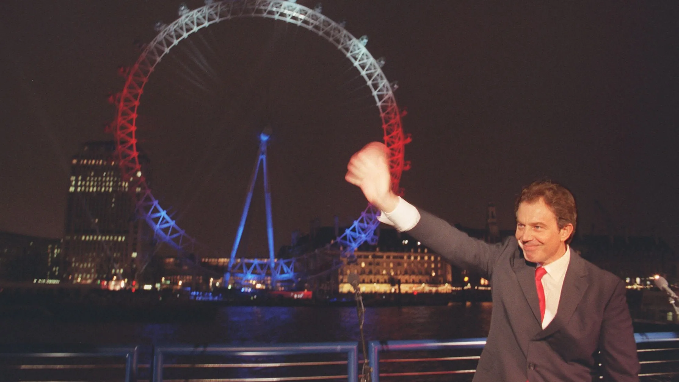 G4W2H2 Prime Minister Tony Blair waves to the crowd after inaugurating the British Airways London Eye alongside the River Thames. No passengers, however, were riding on the world's largest ferris wheel after engineers discovered a fault in one of the 32 pods. * The mechanism on one of the 32 pods was defective.
