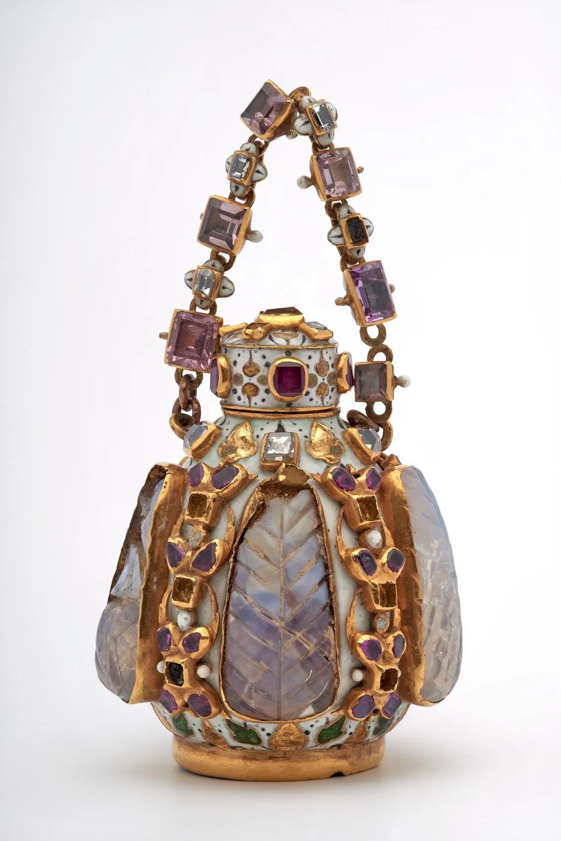 Ornate jeweled container with a gold handle, decorated with purple gemstones and enamel, featuring leaf-shaped crystal panels and intricate detailing.