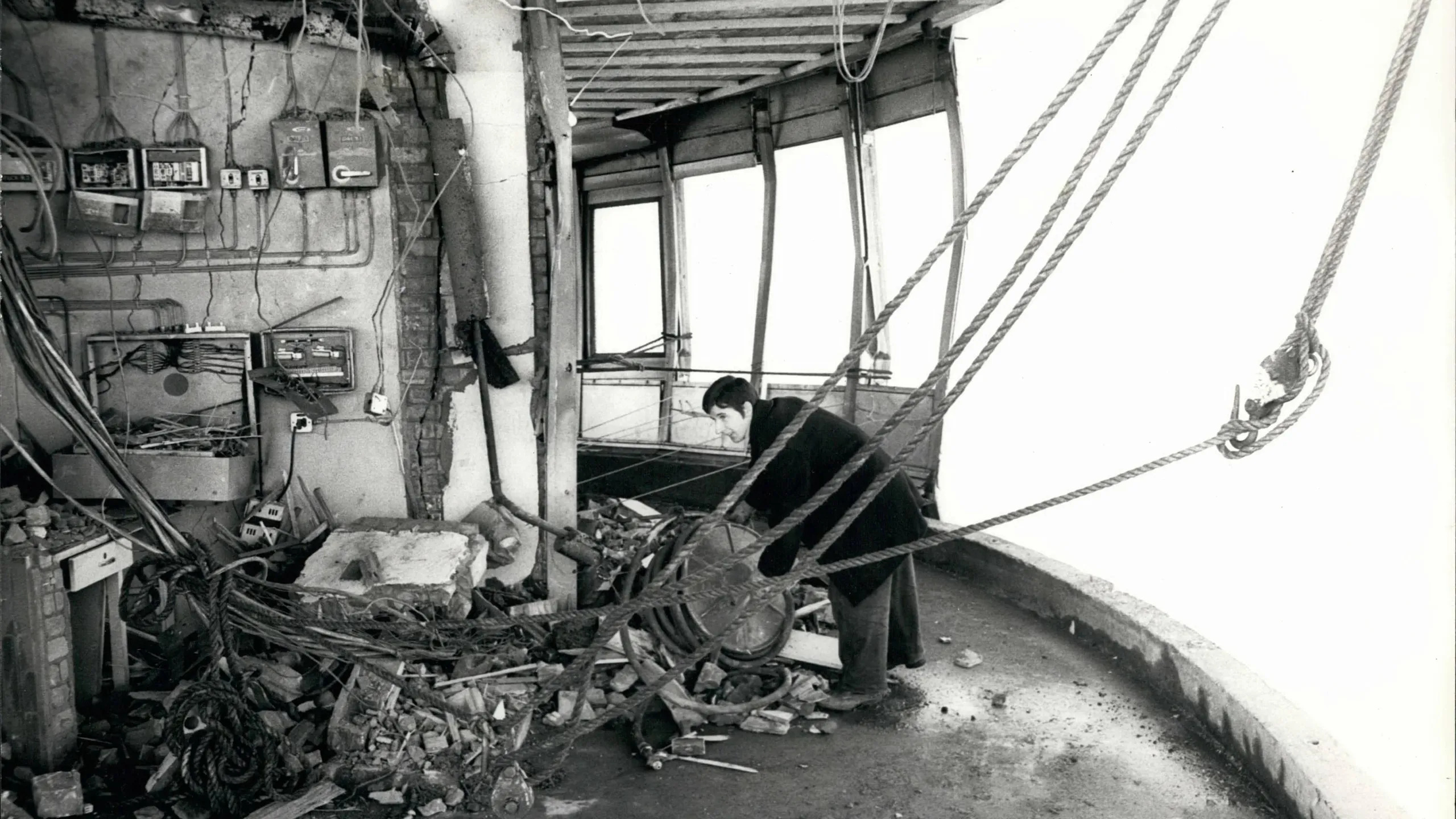 E0YYG1 Nov. 11, 1971 - The Aftermath of the Post Office Tower Explosion: Today the debris being cleared away and clearing up operations were being carried out following yesterday's bomb blast which damaged three floors of the 620-feet high Post Office Tower. Photo shows: A workman is seen clearing away the debris caused by the bomb blast on the 31st floor of the Post Office Tower yesterday.