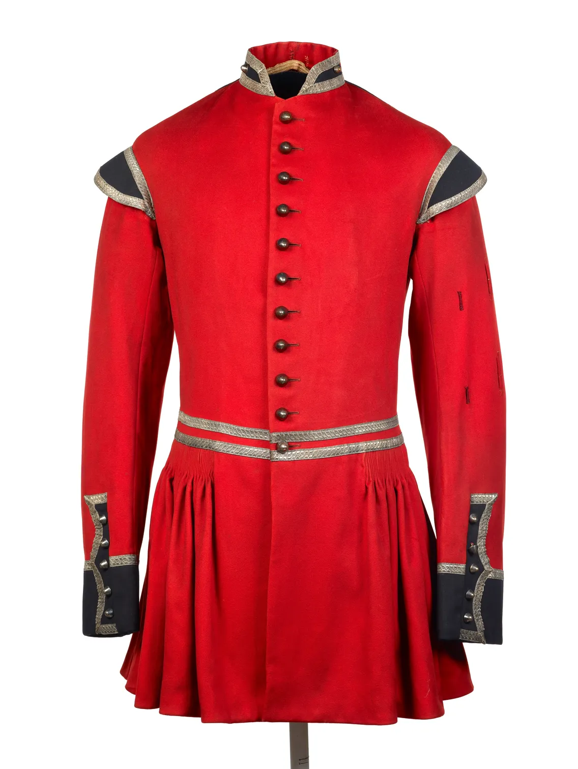 Red historic military jacket with silver buttons and trim, displayed on a mannequin against a white background.
