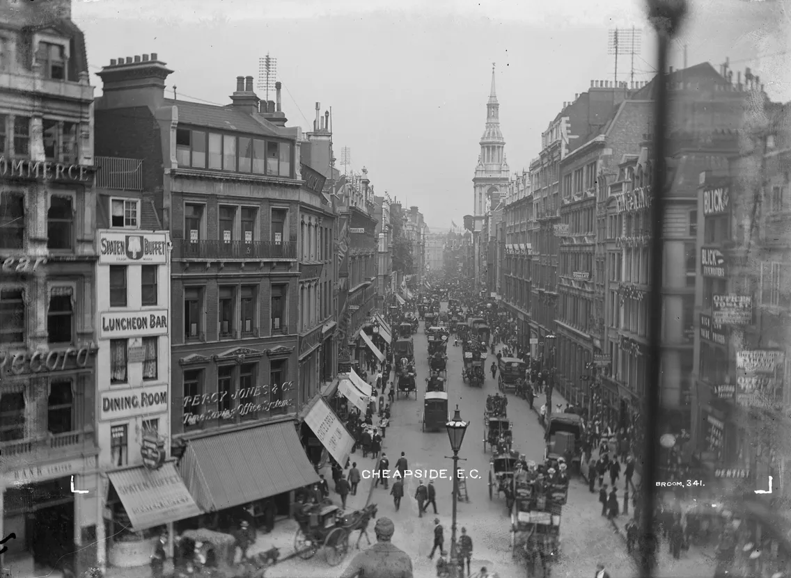 Historical black and white photo of cheapside, london, showing busy street scene with pedestrians and horse-drawn carriages, early 20th century.