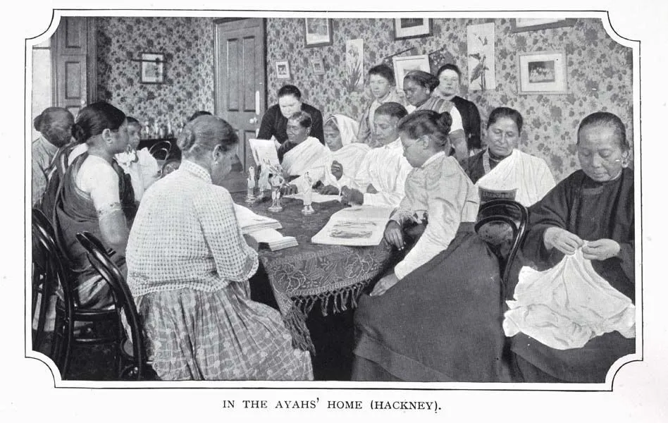 A vintage black and white photo of South Asian women in a room, some reading and others sewing, captioned "In the Ayahs' Home (Hackney).