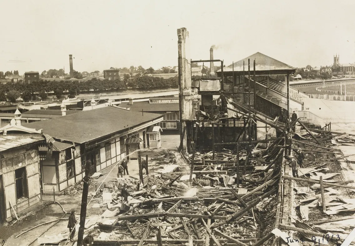 Historical black and white photo of a damaged industrial site with debris and a collapsed structure, dated june 7, 1913.