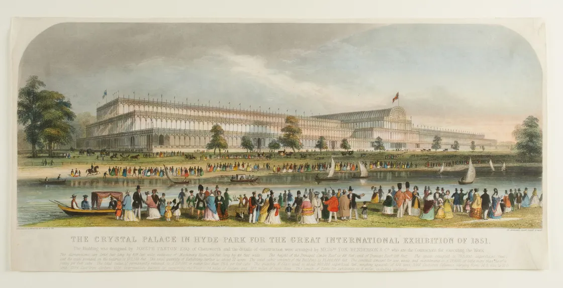 Crowds of people in front of a long glass building with many windows in a park.