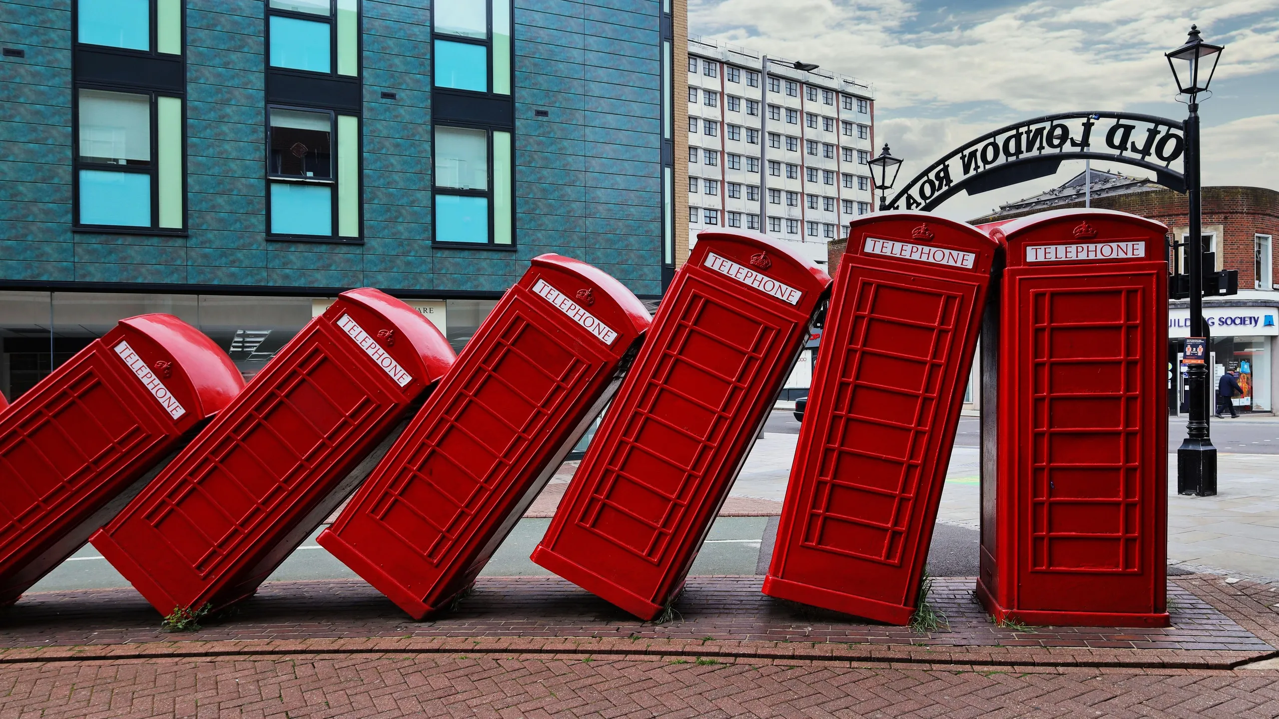 2FYFMCE Out of Order by David Mach - a street sculpture of red telephone boxes in Old London Road, Kingston upon Thames, Greater London, England, UK